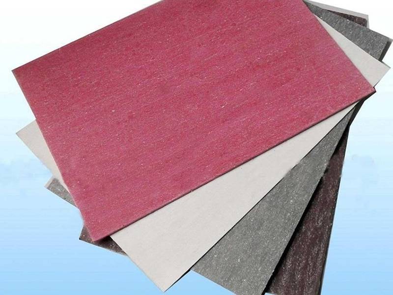 Oil-resistant paronite sheets in red, white, grey and brown colors on blue background